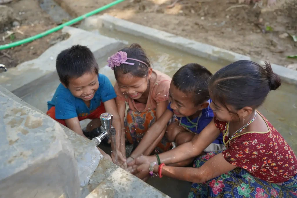 Families in flood-prone communities collecting clean drinking water