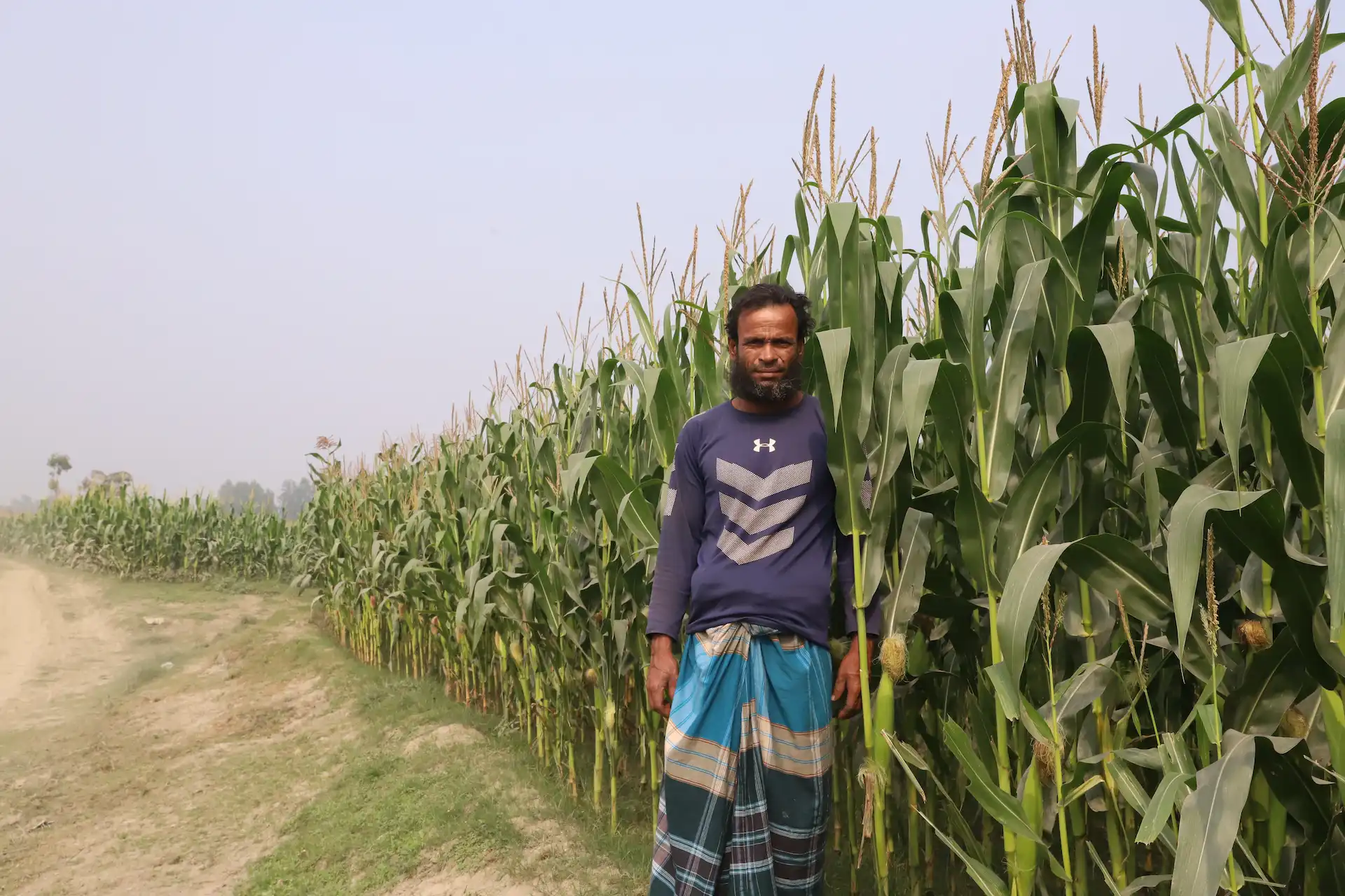 Farmer standing beside crops