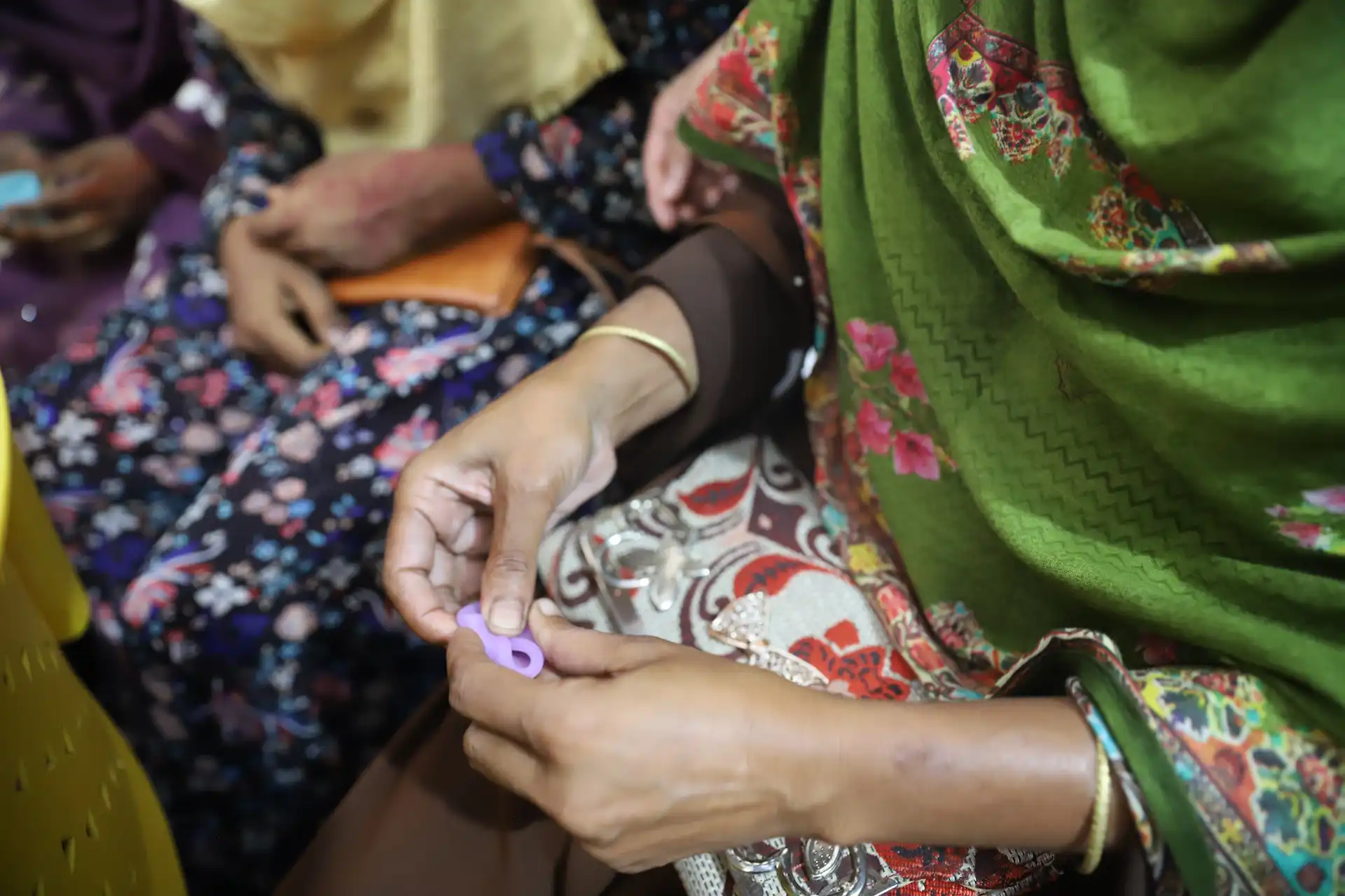 Health worker leading a menstrual health training session with coastal women