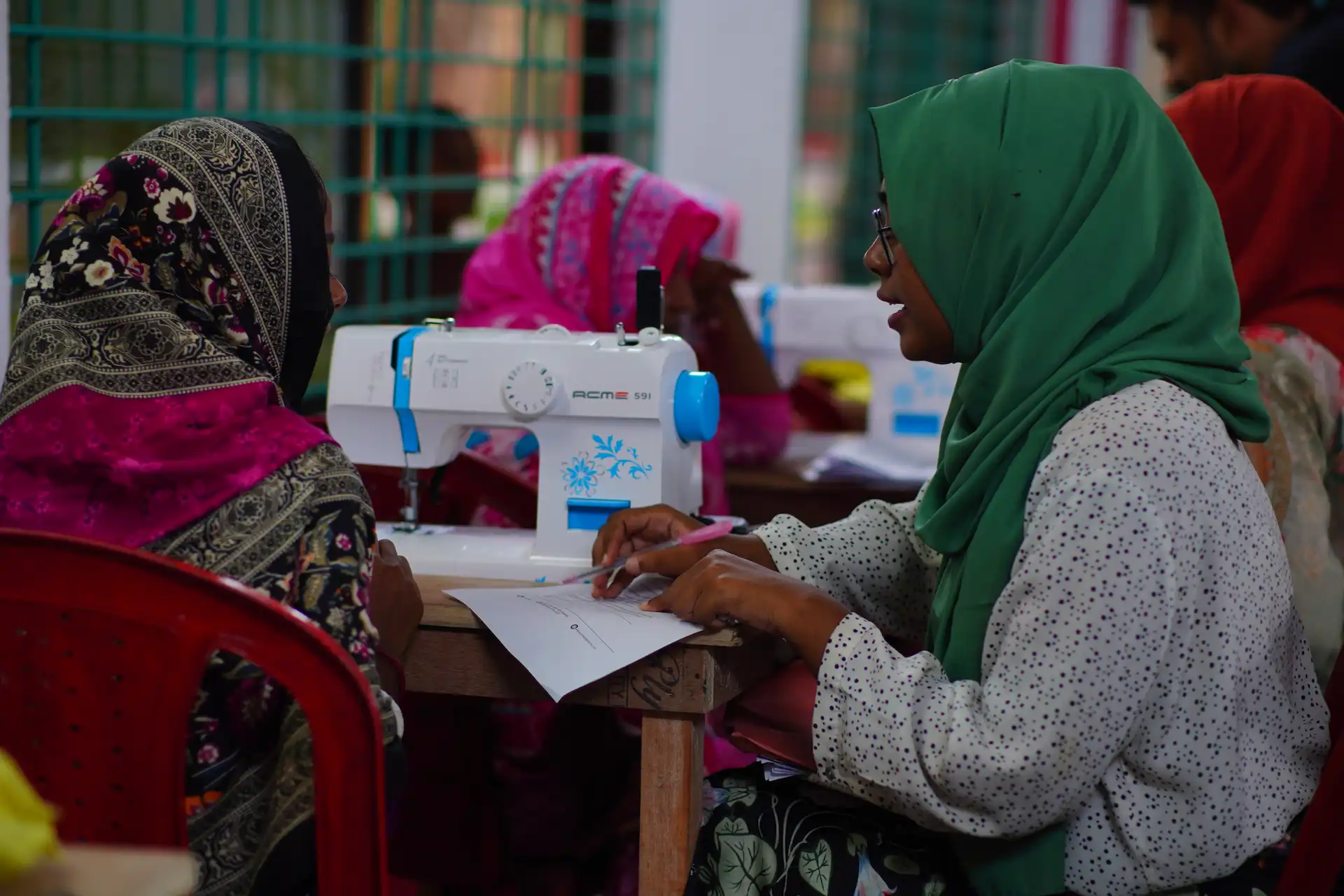 Rural women learning to sew in a community training session